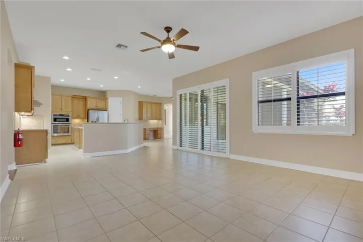 Unfurnished living room with recessed lighting, a ceiling fan, and light tile patterned floors