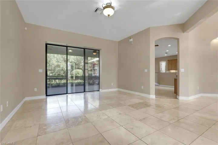 Empty room with baseboards and arched walkways