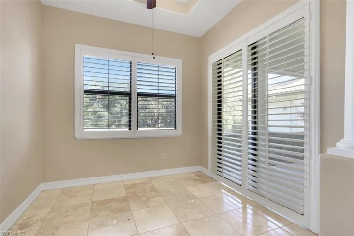 Unfurnished room with a ceiling fan and baseboards