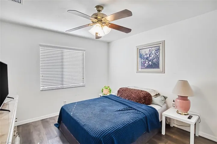 Bedroom featuring dark wood finished floors and a ceiling fan
