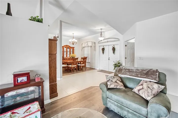 Living room with light wood-style flooring and a chandelier