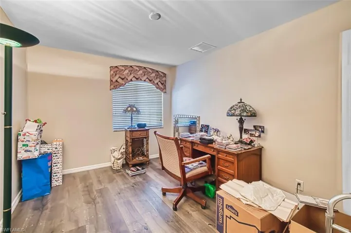 Office area with wood finished floors and baseboards