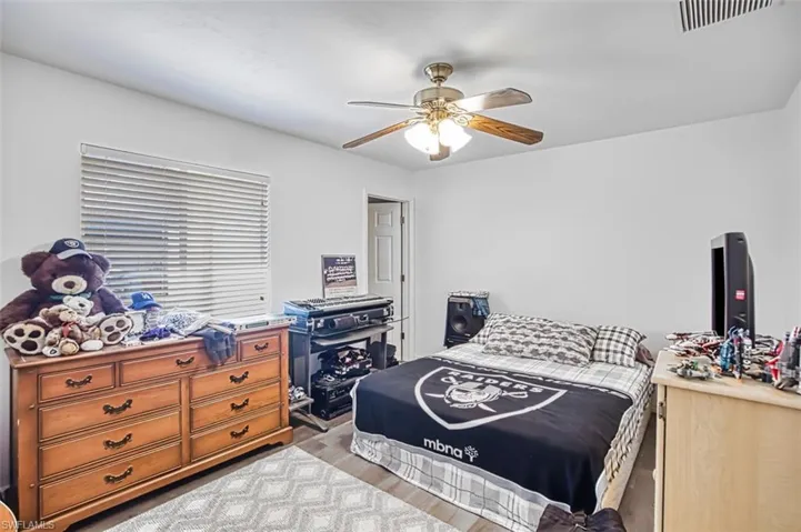 Bedroom featuring ceiling fan and light wood-type flooring