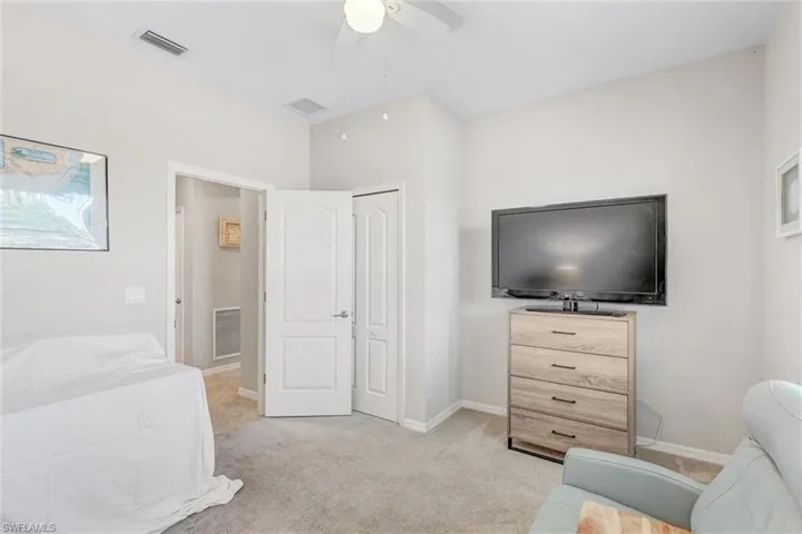 Bedroom featuring light carpet and a ceiling fan