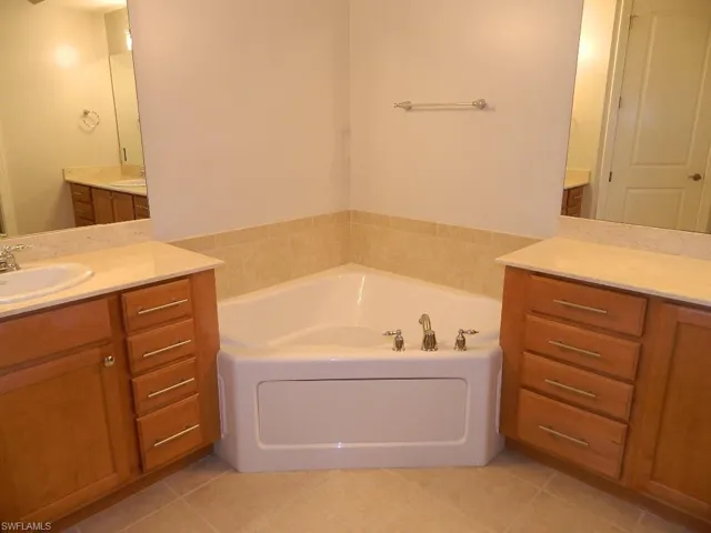 Spare room with light colored carpet and baseboards