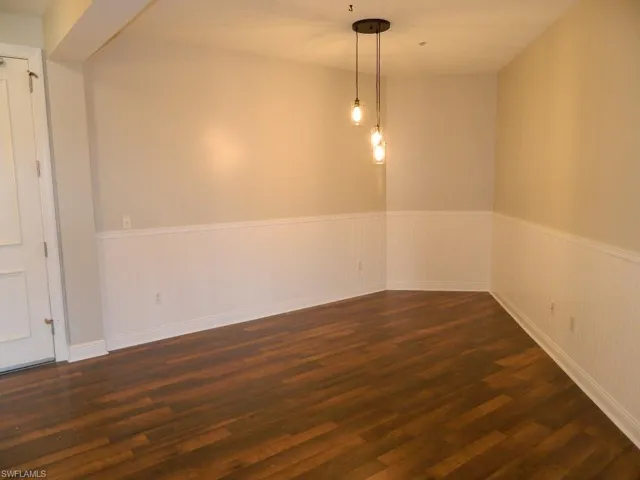 Empty room with light carpet and a ceiling fan