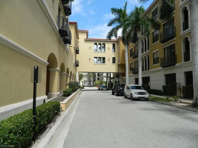 View of asphalt road with curbs and sidewalks