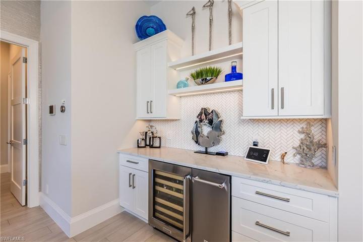 Wet bar with stand alone ice maker and wine fridge.