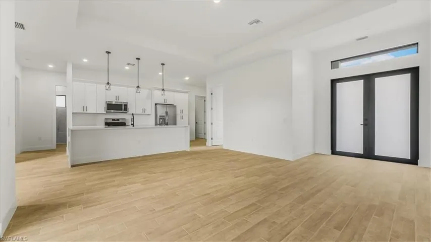 Unfurnished living room featuring recessed lighting and light wood finished floors