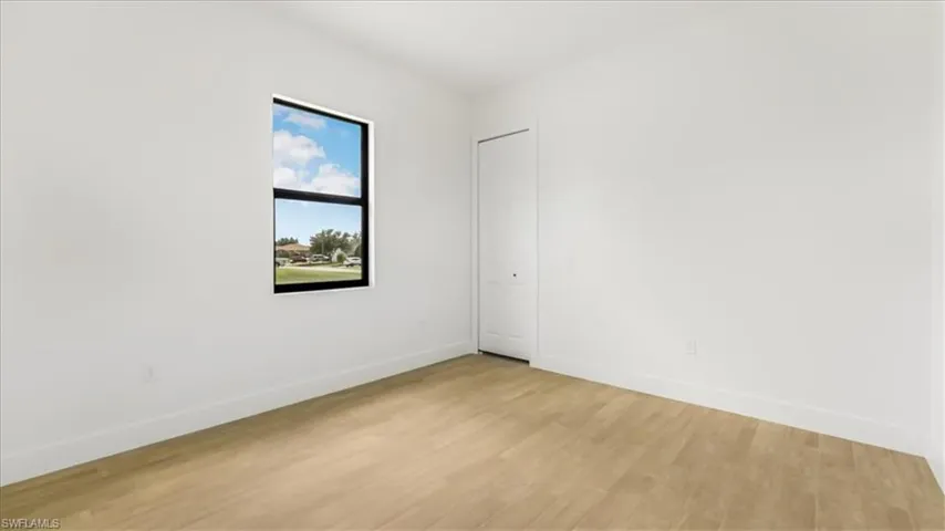 Spare room with light wood-style flooring and baseboards