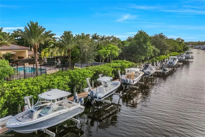 View of dock featuring a water view and a community pool