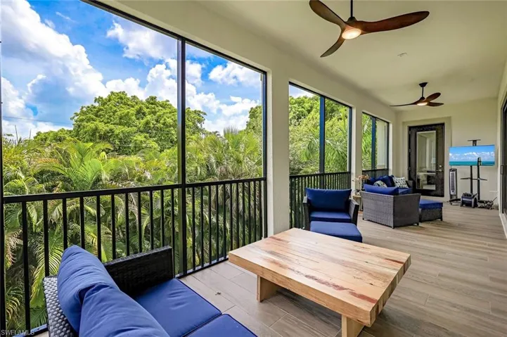 Back Porch off living room & kitchen area featuring ceiling fans & plenty of space.