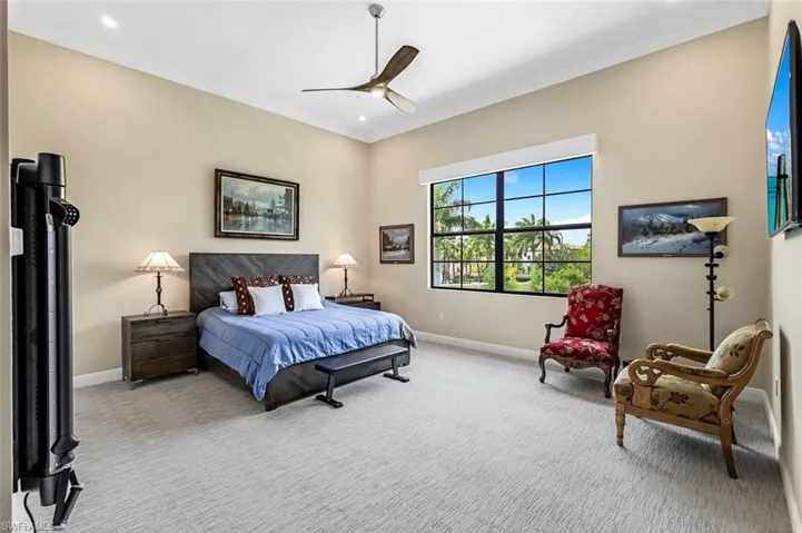 Ensuite #2 w/carpeted bedroom featuring ceiling fan, Lutron lighting, shades, walk in closet & tons of extra space