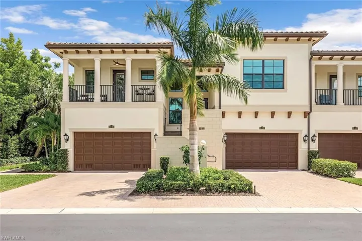 Mediterranean / spanish-style home with a garage and a balcony