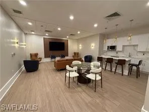 Living room with light wood finished floors and recessed lighting