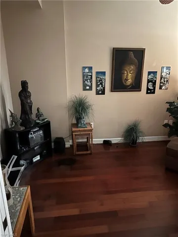 Living area with wood finished floors and baseboards