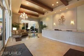 Welcome area featuring beam ceiling and suspended lighting