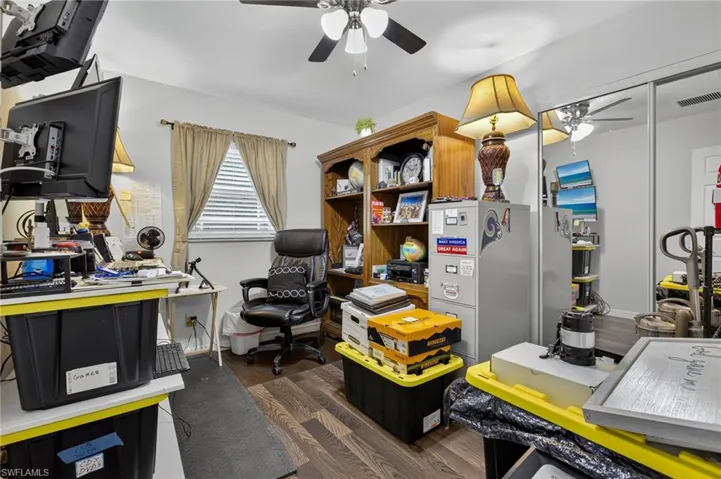 Home office with ceiling fan and wood finished floors