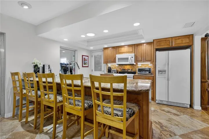 Dining space featuring recessed lighting and a tray ceiling