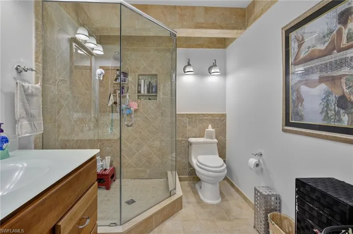 Bathroom featuring vanity, tile patterned flooring, and a stall shower