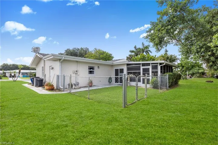 Rear view of property with a sunroom and stucco siding