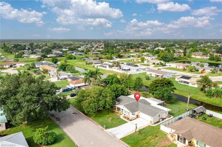 Aerial view of residential area featuring a large body of water
