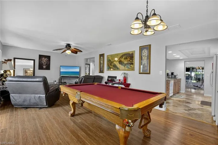 Game room with billiards, ceiling fan, and light wood finished floors