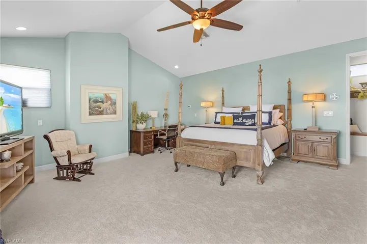 Primary upstairs Bedroom with ceiling fan, new carpet, baseboards, cathedral ceiling, and recessed lighting and Best River View