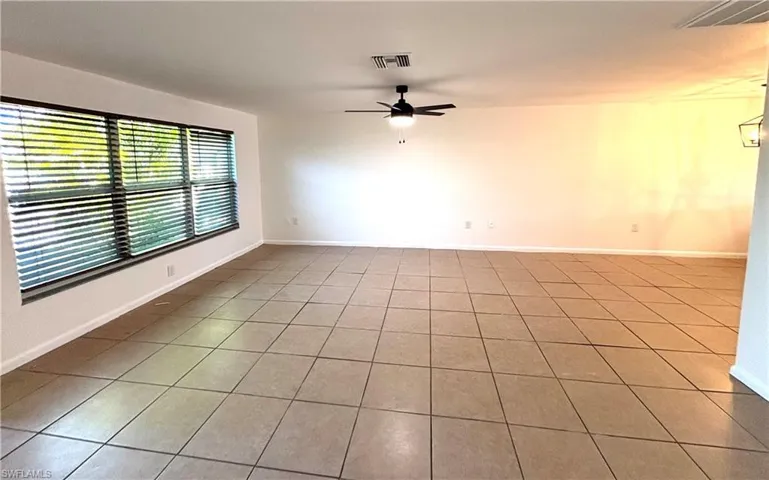 Spare room featuring tile patterned flooring and ceiling fan