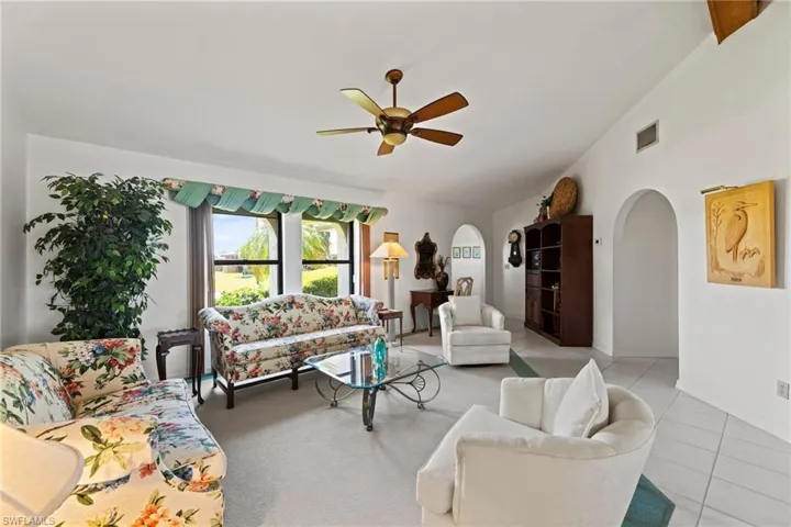 The living room has large windows allowing natural light to fill the rooms.  The vaulted ceilings creates openness.
