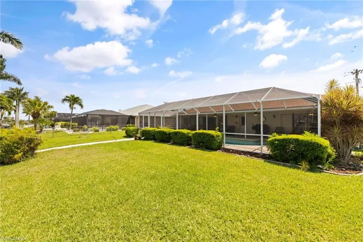 There is a large back yard with beautiful lawn.