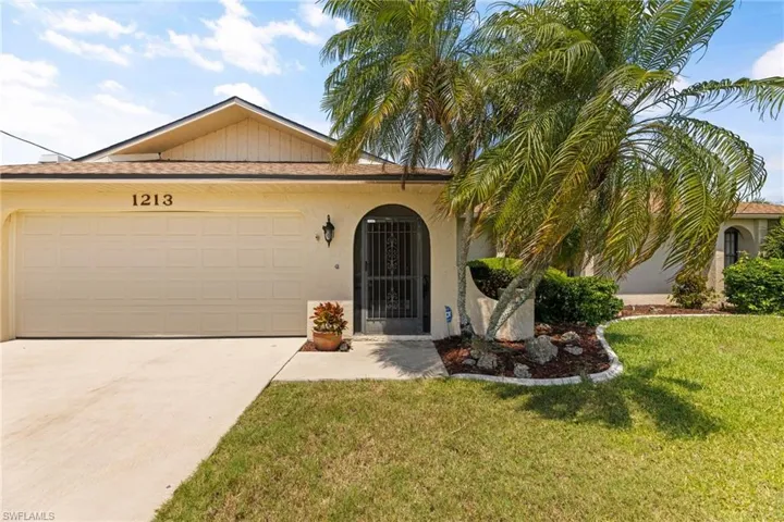 The front elevation is charming with a  screened-in porch that leads to the front door.  The 2 car garage has an additional exit door to the side where garbage cans are kept.