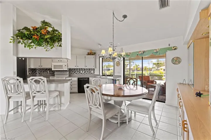 The Dining area has built in cabinets with lovely glass doors. You could have dinner with views of lanai, pool and canal.