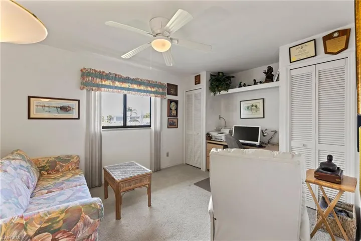 back bedroom has built in desk and closet with views of the backyard and canal