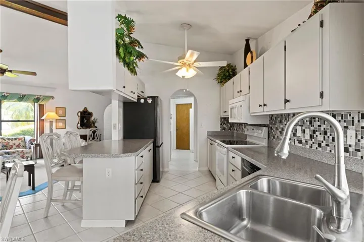 The Kitchen sink faces out to the lanai, pool and canal.  Watch the boats go by while doing the dishes!