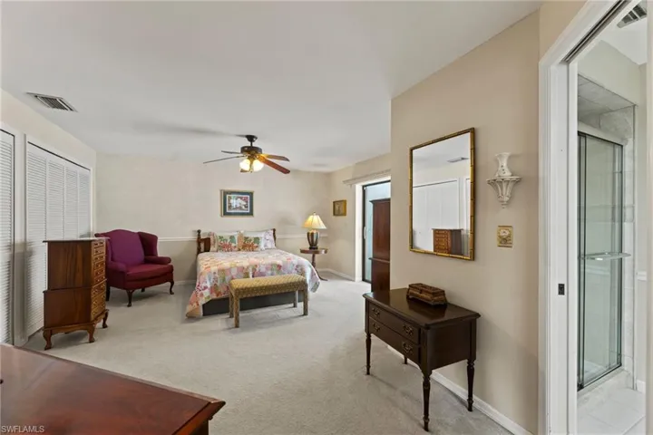 large master bedroom with closets that go from wall to wall