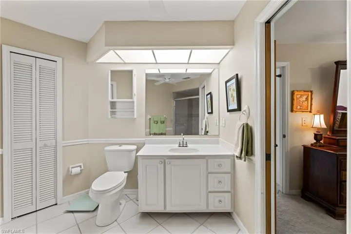 master bath has linen closet, shower and door to lanai & pool