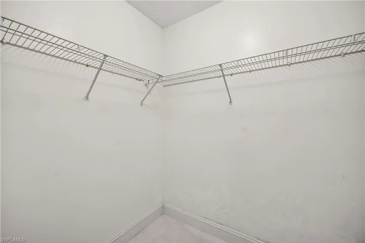 White interior walls featuring wire shelving