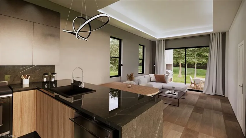 Kitchen featuring dark stone countertops, a raised ceiling, tasteful backsplash, dark wood finished floors, and a chandelier