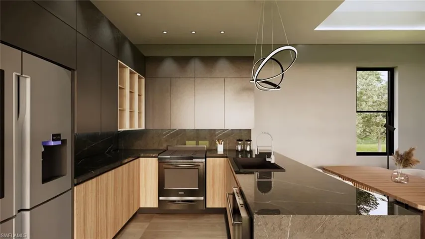 Kitchen with stainless steel appliances, hanging light fixtures, a peninsula, dark stone countertops, and tasteful backsplash