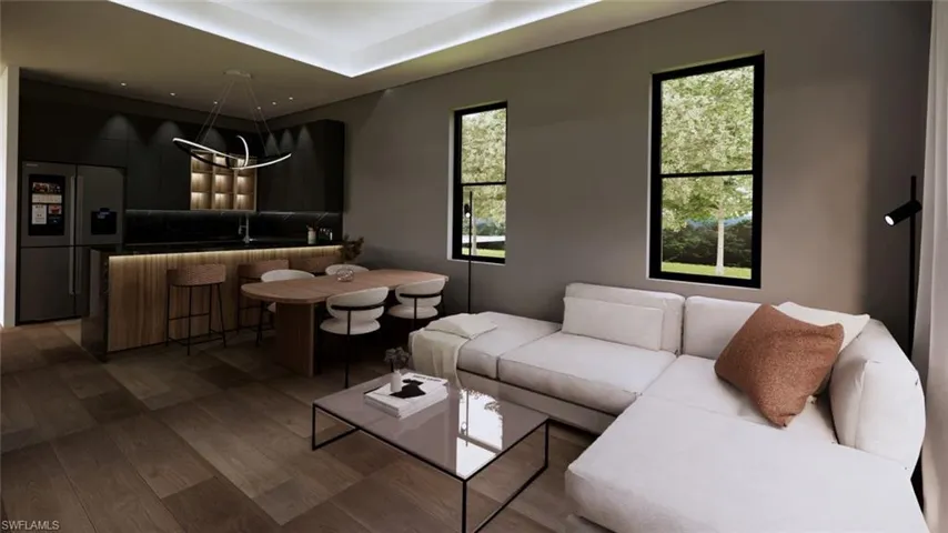 Living room with wood finished floors and a tray ceiling
