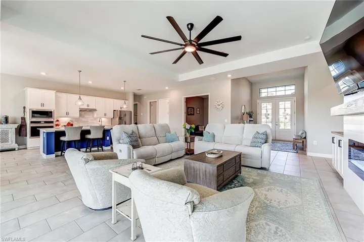 Living area featuring custom cabinetry living area with built in electric fireplace, recessed lighting and plank tile in this Great Room Floor Plan