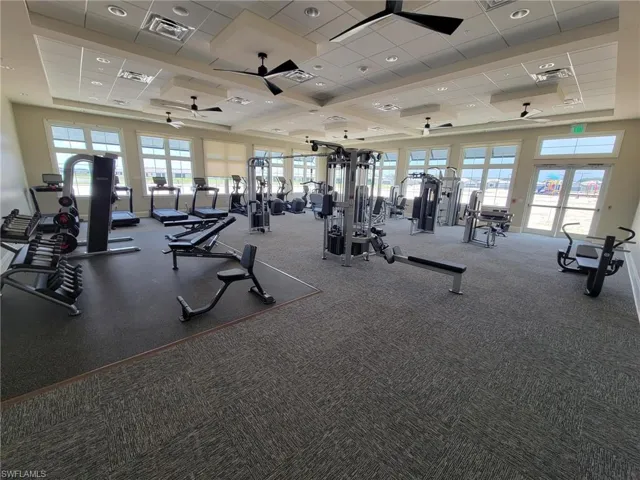 Workout area with visible vents, a ceiling fan, and a drop ceiling