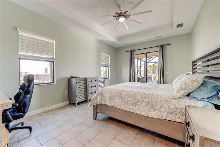 Primary Bedroom featuring a tray ceiling