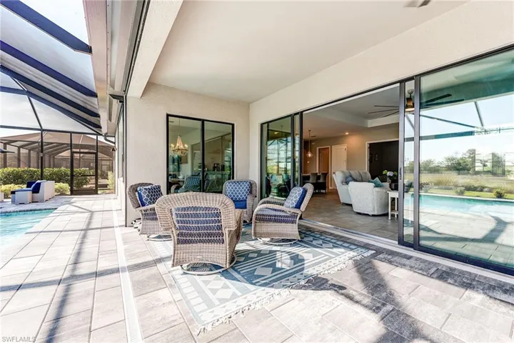 View of covered patio / terrace featuring a lanai and an outdoor pool, spa, expansive deck