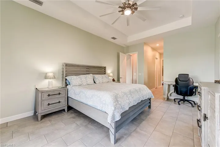 Primary Bedroom featuring a tray ceiling