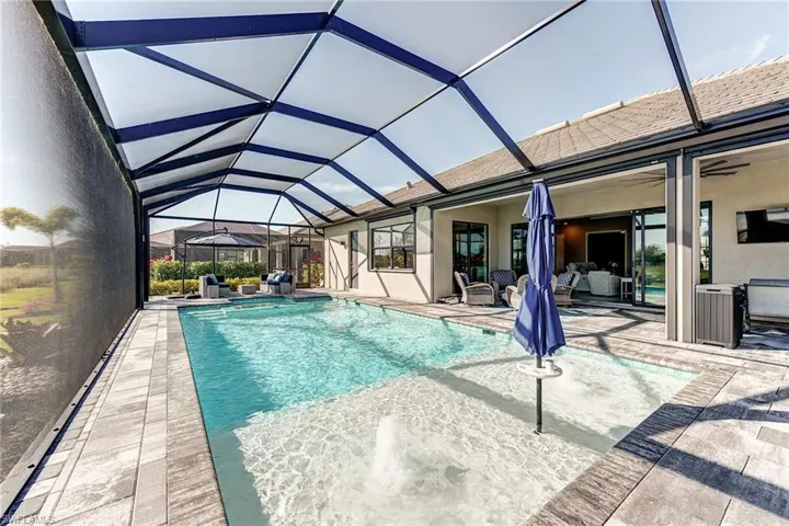 Heated Pool with Spa screened enclosure and a patio