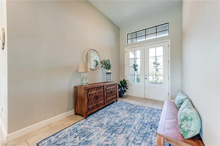 Entrance foyer featuring elegant double doors with glass inserts and glass top panels