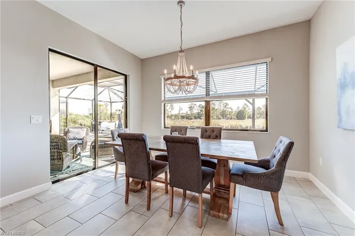 Dining area with baseboards and an inviting chandelier