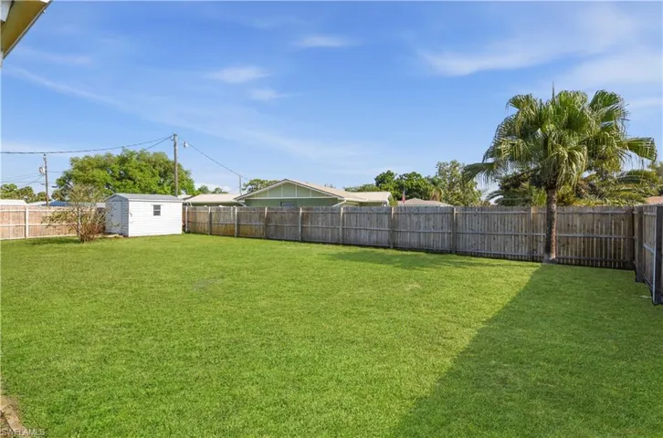 Fenced backyard with a storage shed